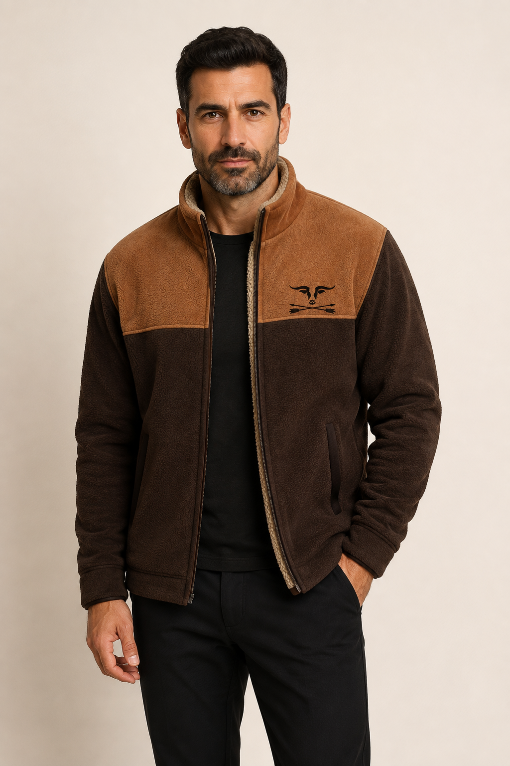 Men's dark brown fleece jacket with rust yoke and sherpa lining, worn by model in warm beige studio