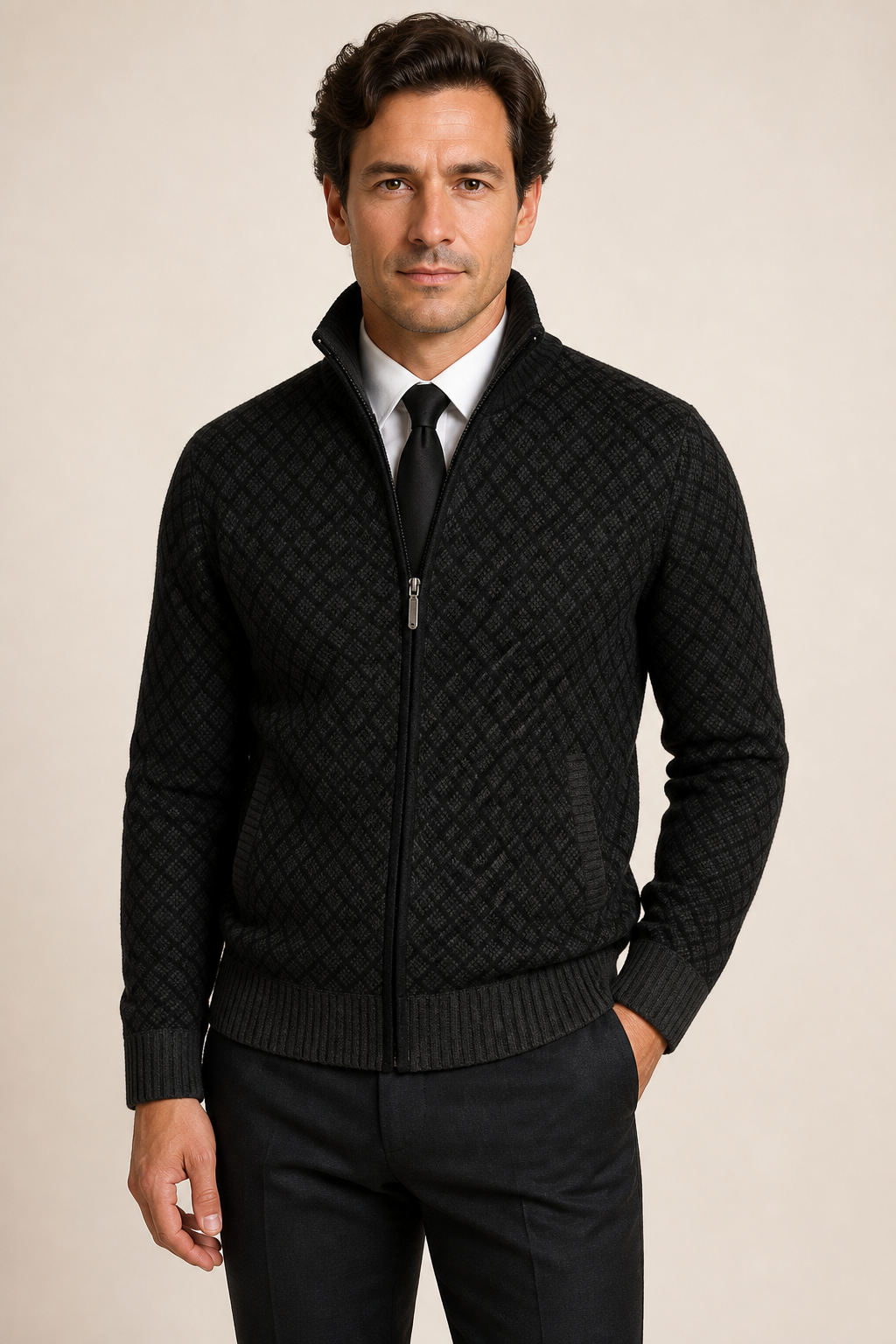 Men's black diamond-knit zip cardigan over shirt and tie, worn by model in warm beige studio