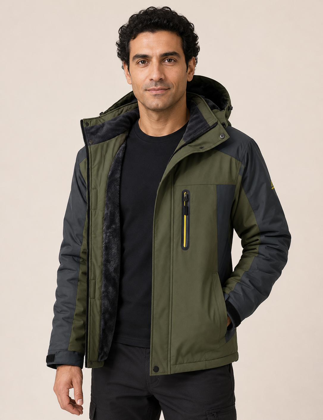 Men's olive and charcoal waterproof technical jacket, worn by model in warm beige studio
