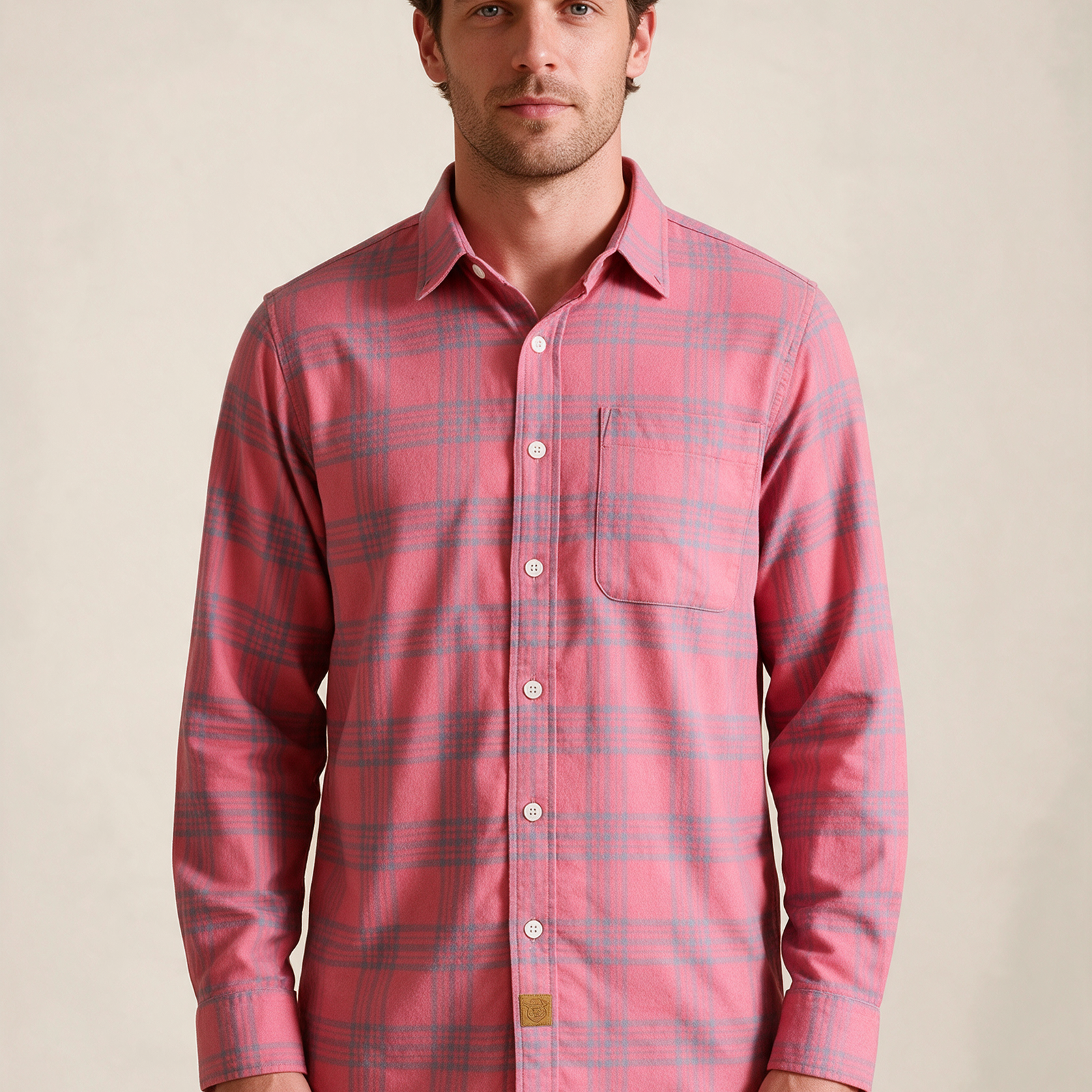 Modelo masculino a usar a camisa em fundo bege